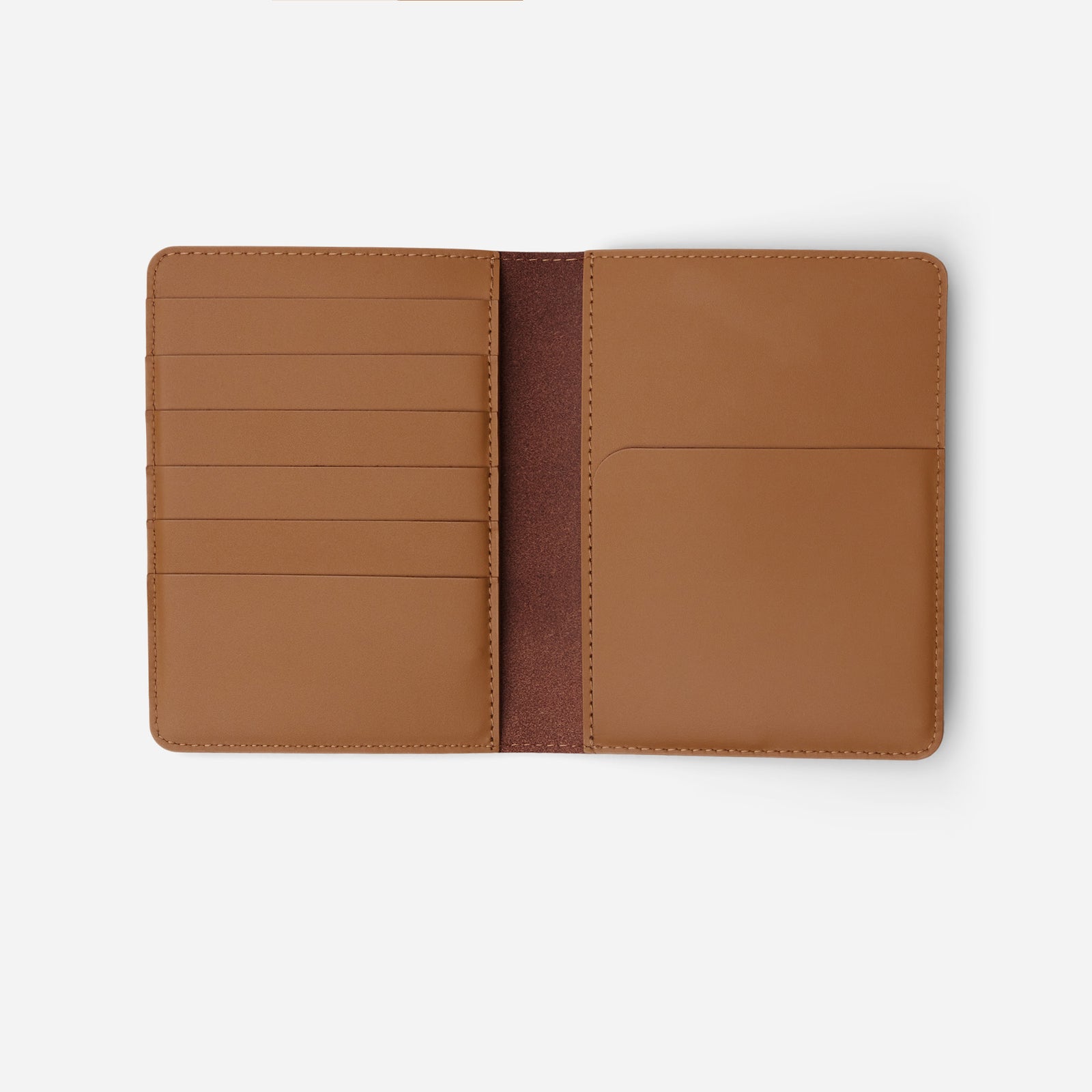 Atlas passport holder in saddle brown full-grain leather, open view showing organized card slots and compartments