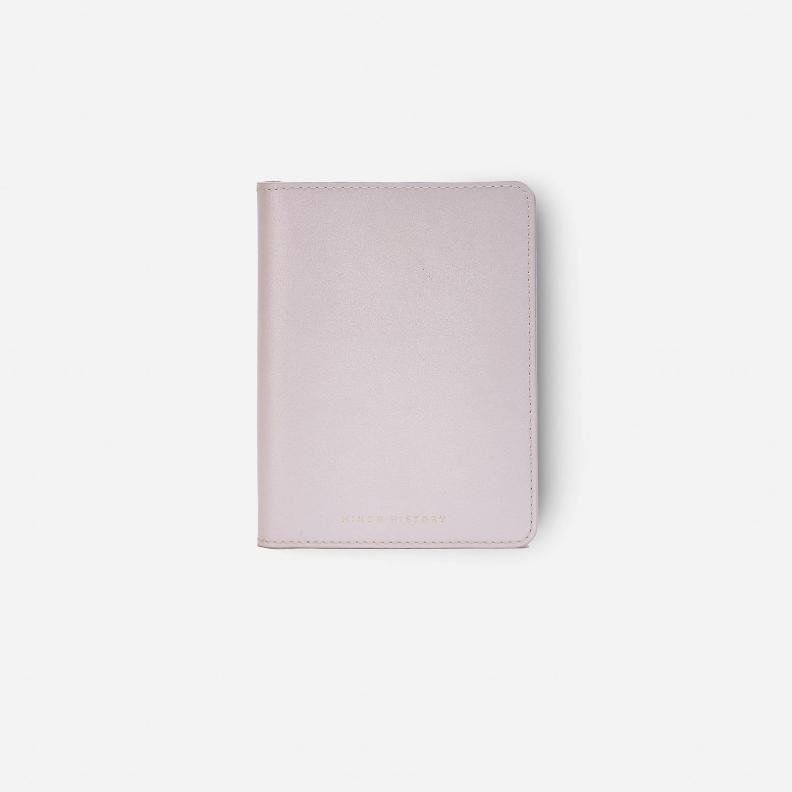 Atlas passport holder in pearl white full-grain leather, side view highlighting slim profile