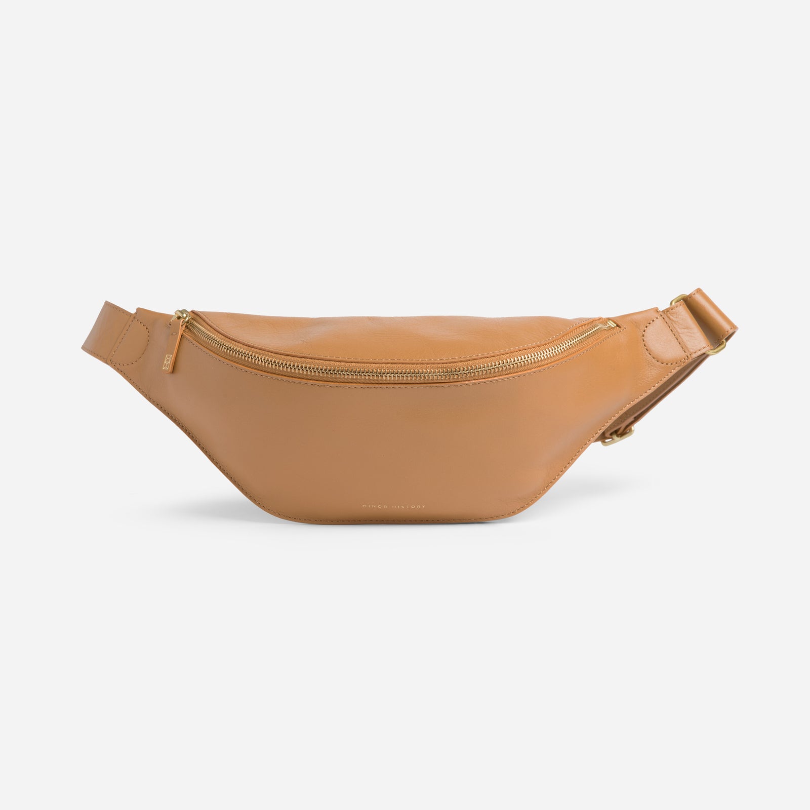 Crosstown fanny pack in saddle brown full-grain leather, lifestyle image styled with casual outfit
