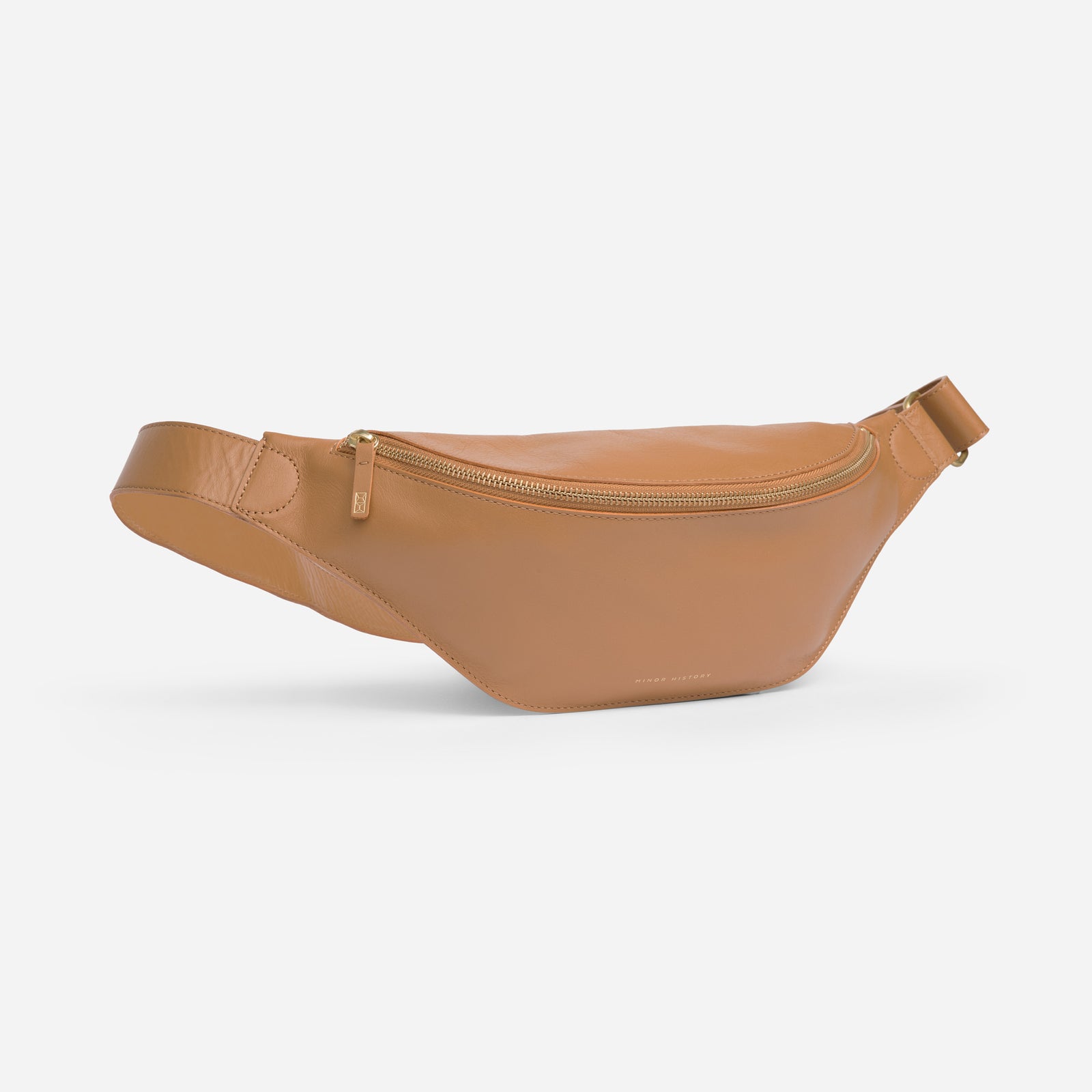 Crosstown sling bag in saddle brown full-grain leather, open view showing organized compartments