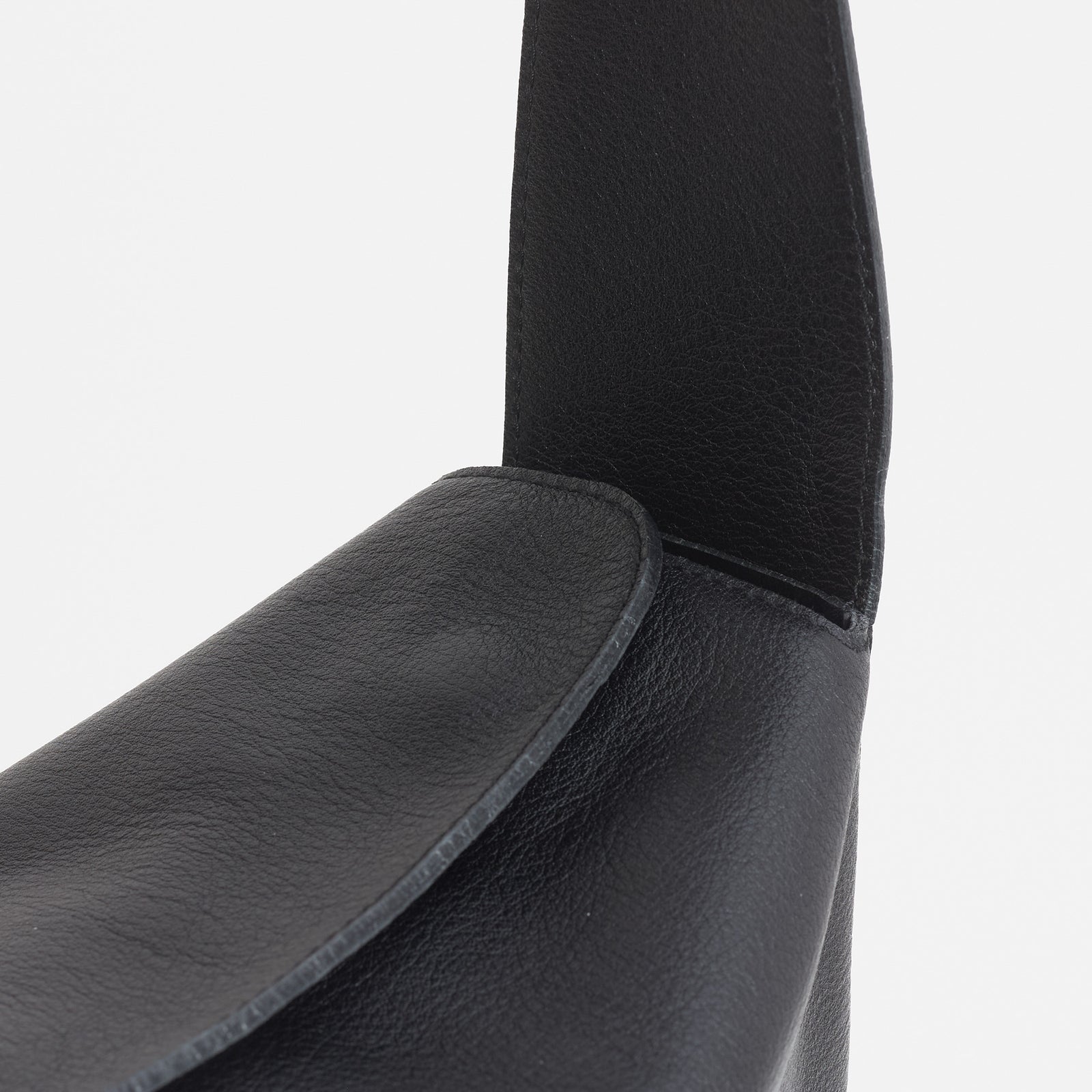 Frame Bag in black full-grain leather, detailed studio shot capturing texture and strap design