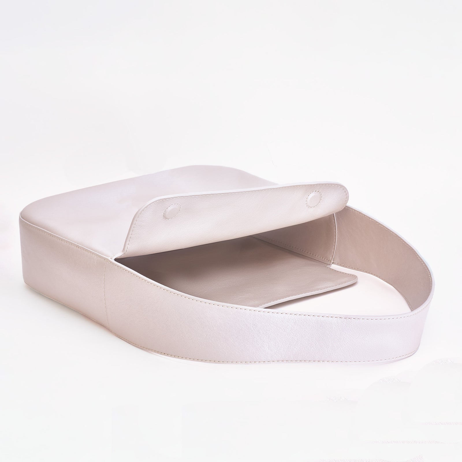 Frame Bag in pearl full-grain leather, minimalist women's handbag in a bright studio setting