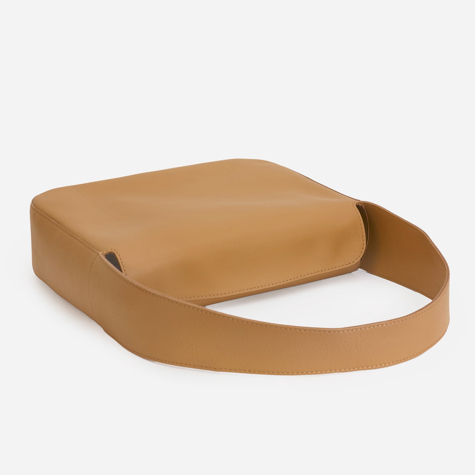 Frame Bag in saddle brown full-grain leather, detailed studio shot capturing texture and strap design