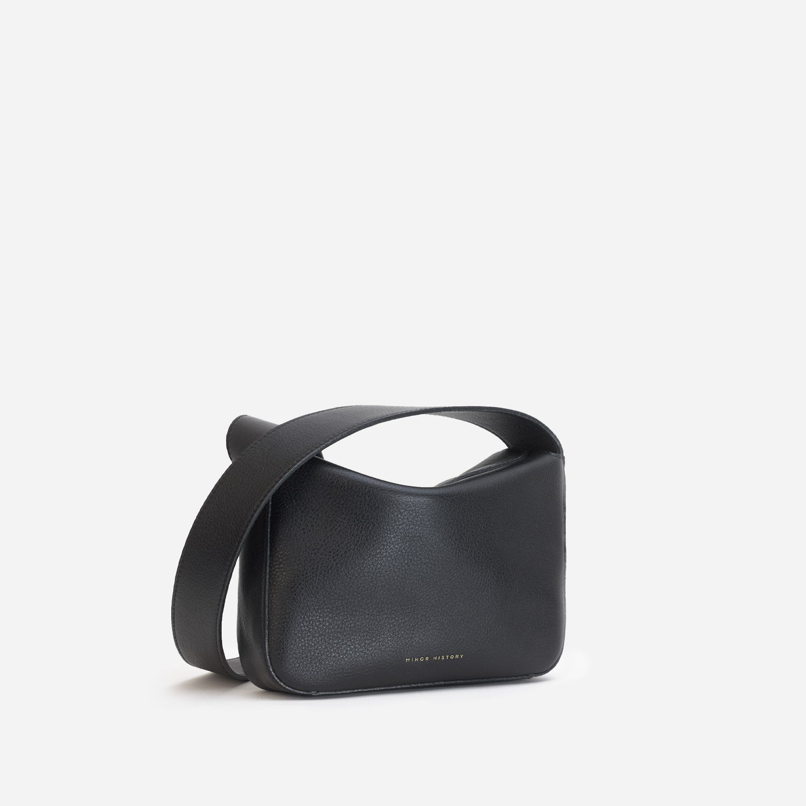 Little Frame crossbody bag in black full-grain leather, front view showcasing its sculpted shape, minimalist women's handbag