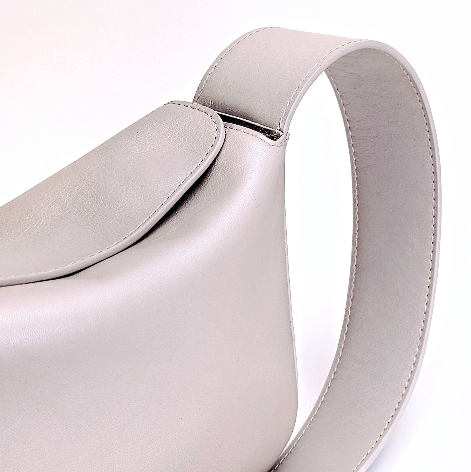 Little Frame crossbody bag in pearl full-grain leather, displayed open to show double-lined interior, minimalist women's handbag