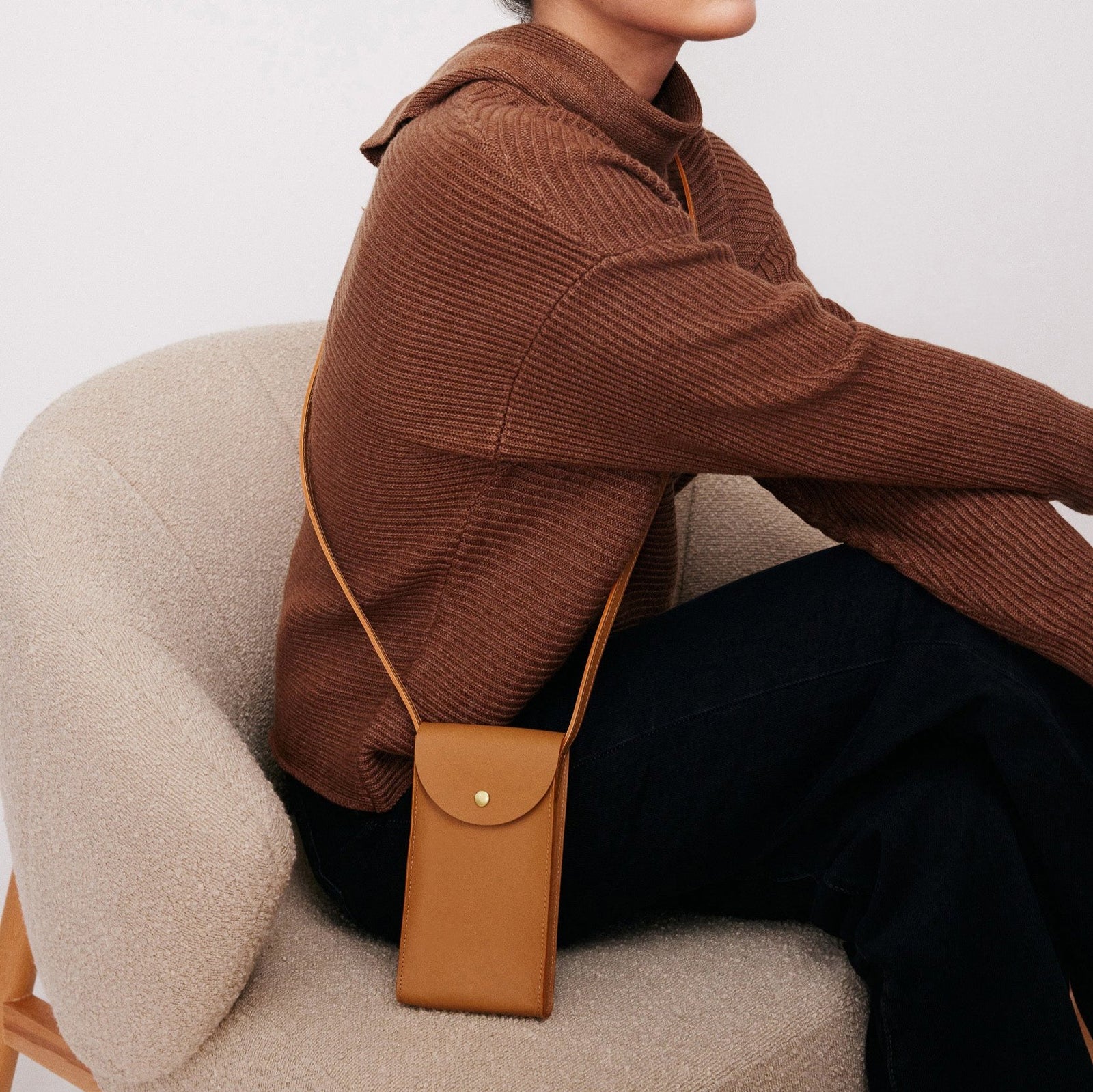 Mini Bandit crossbody bag in saddle brown full-grain leather, open view showing interior and compartments