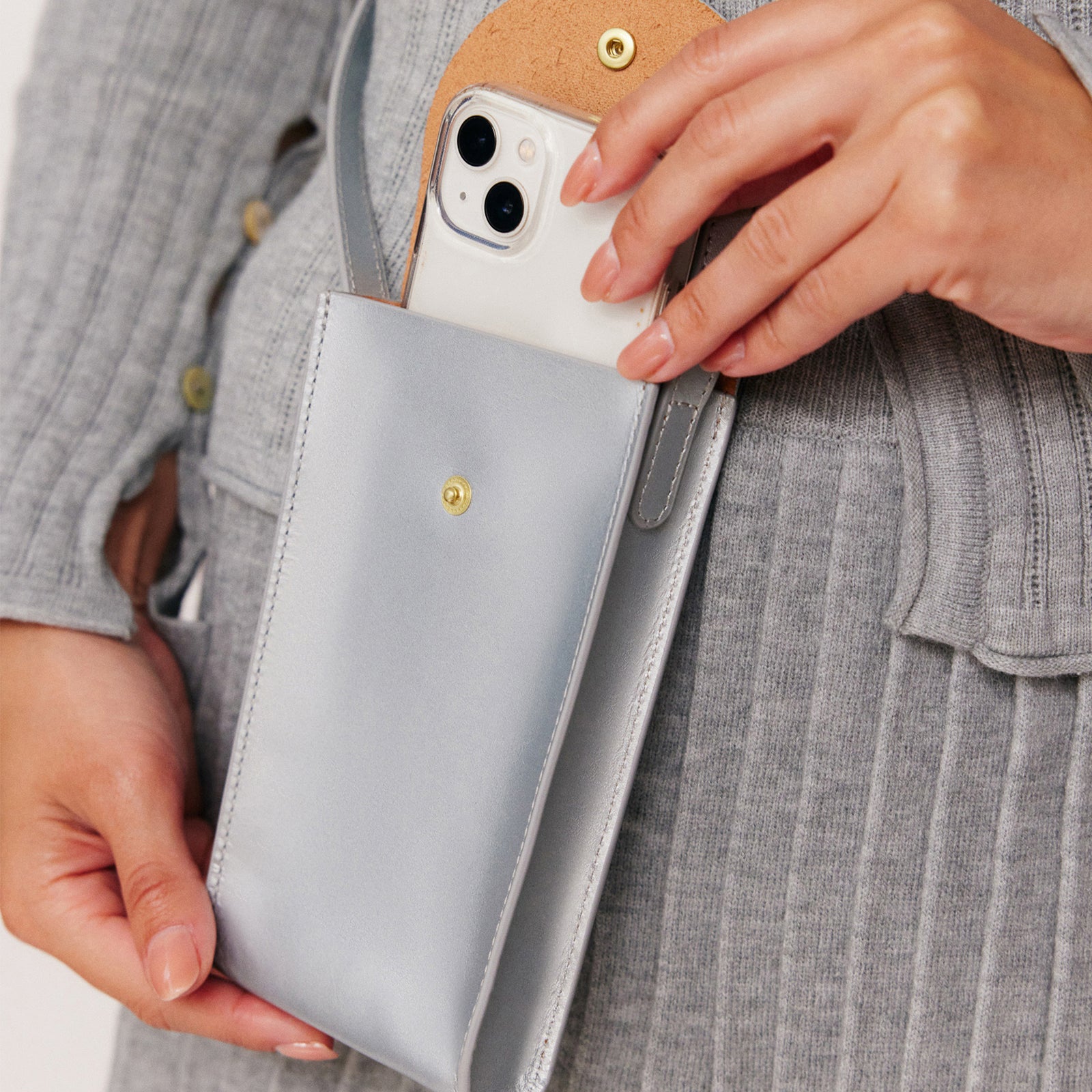 Mini Bandit crossbody bag in sterling silver full-grain leather, cropped view highlighting texture and stitching