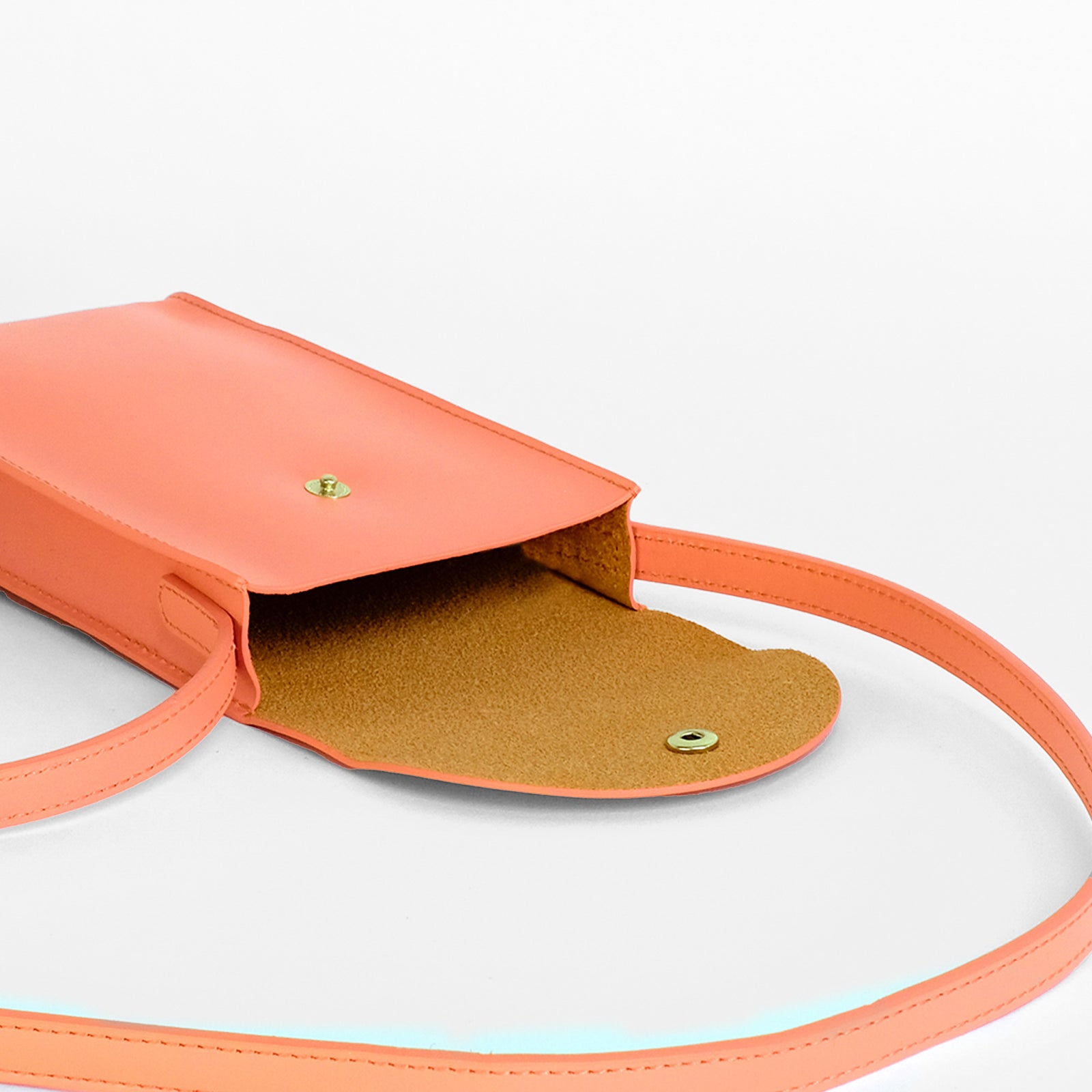 Mini Bandit crossbody bag in paloma pink full-grain leather, lifestyle image styled with casual outfit