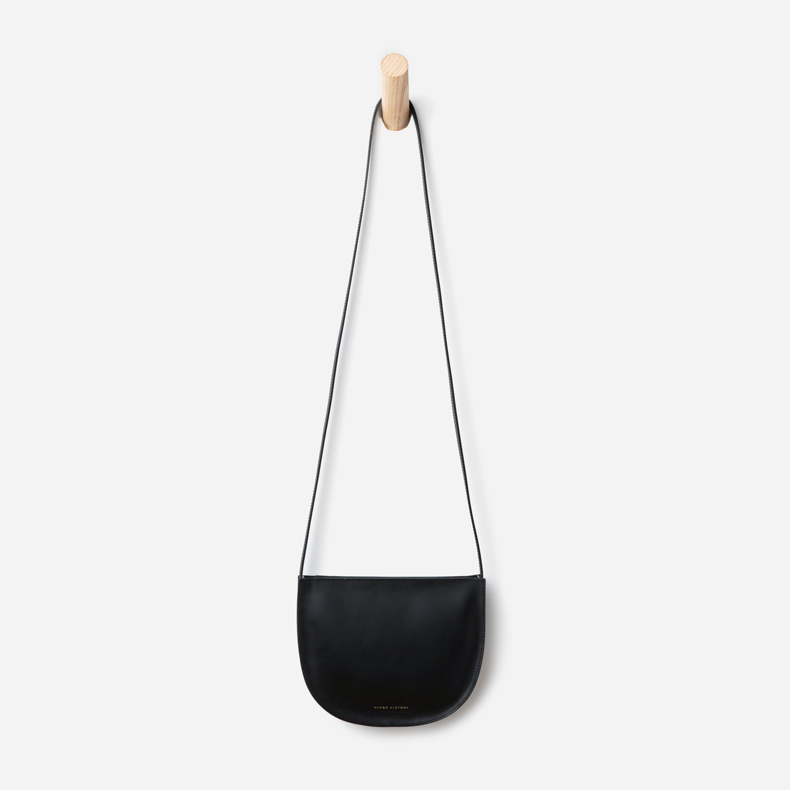 Close-up of Sidekick Crossbody bag in black leather