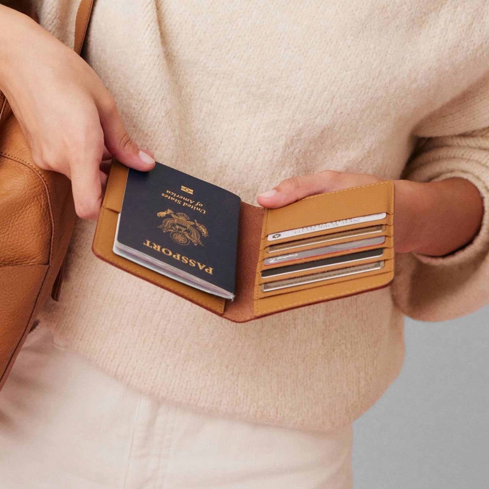 Atlas passport holder in luxury full-grain leather, front view in bright studio setting