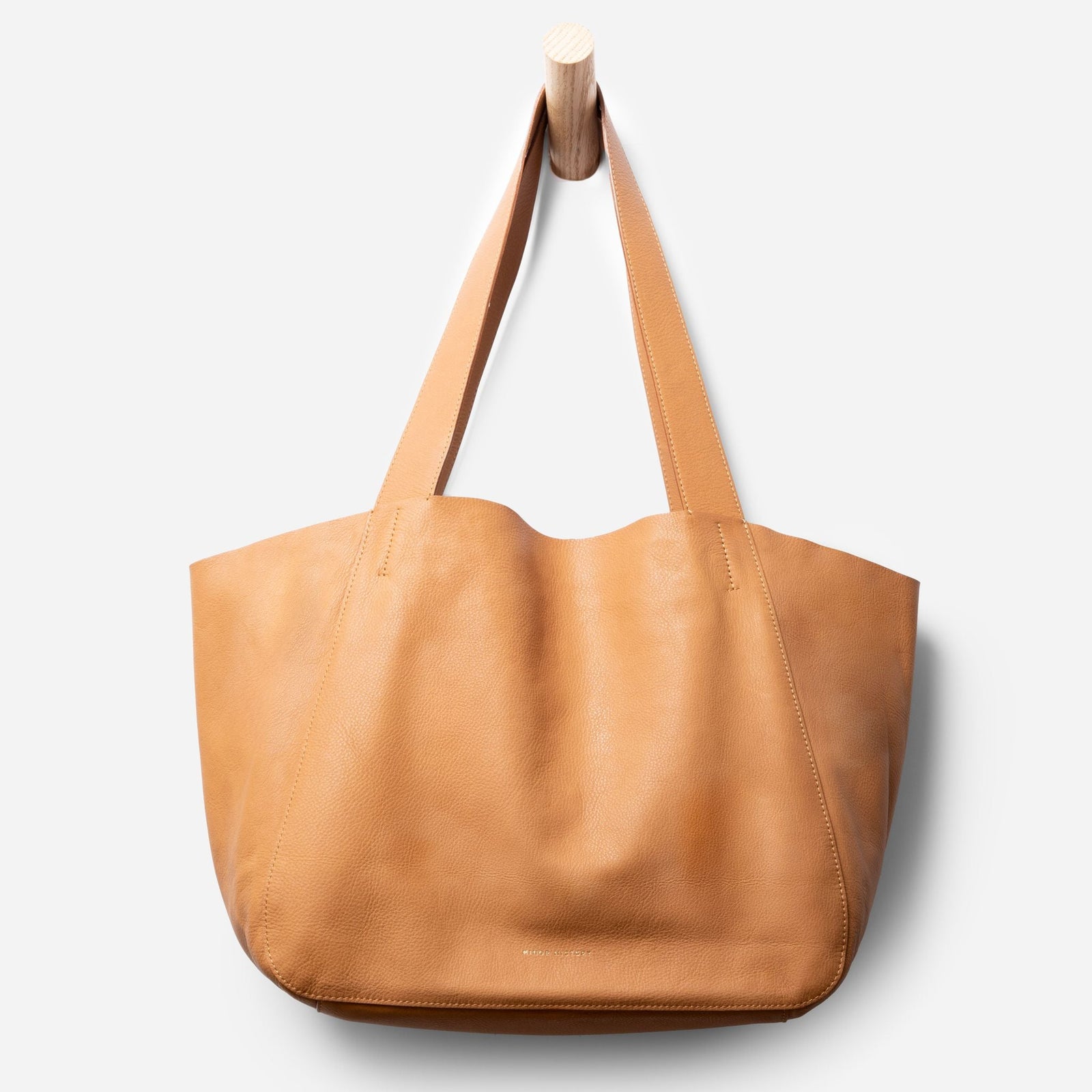 Lifestyle image featuring Times Tote leather bag in everyday setting