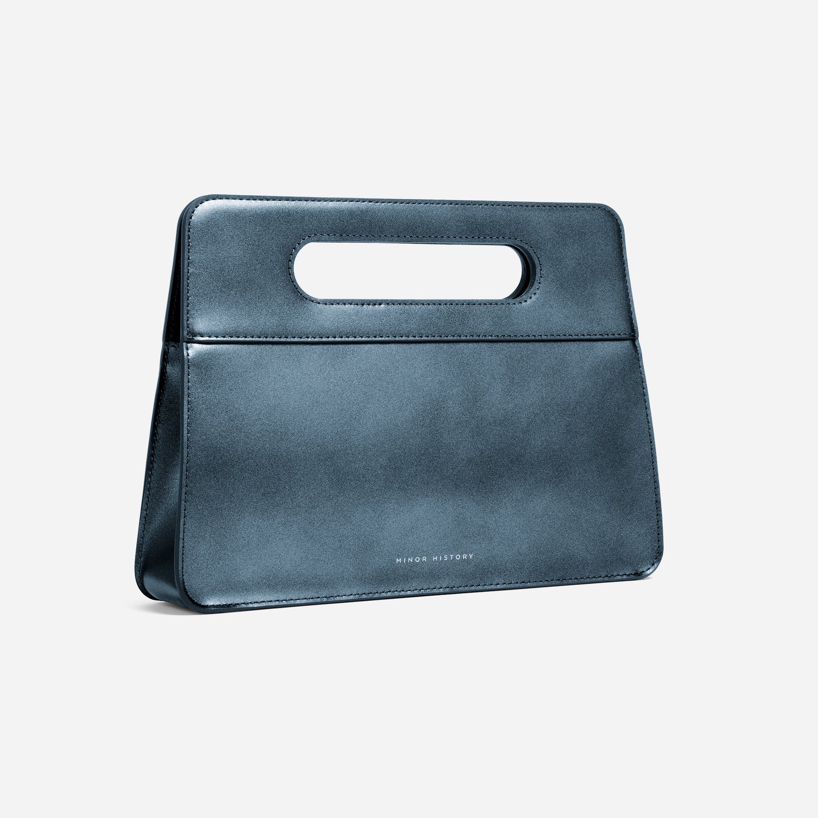 Front view of Jet black leather Afterparty clutch with clean backdrop