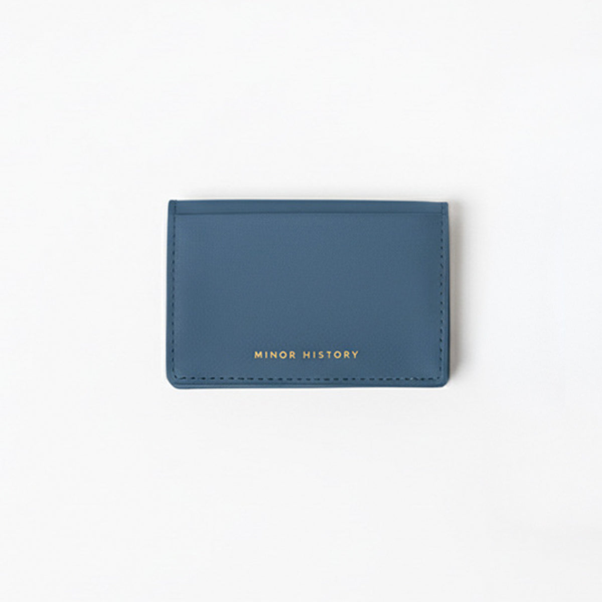 Blue cardholder with 'MINOR HISTORY' branding on a white background - Chambray