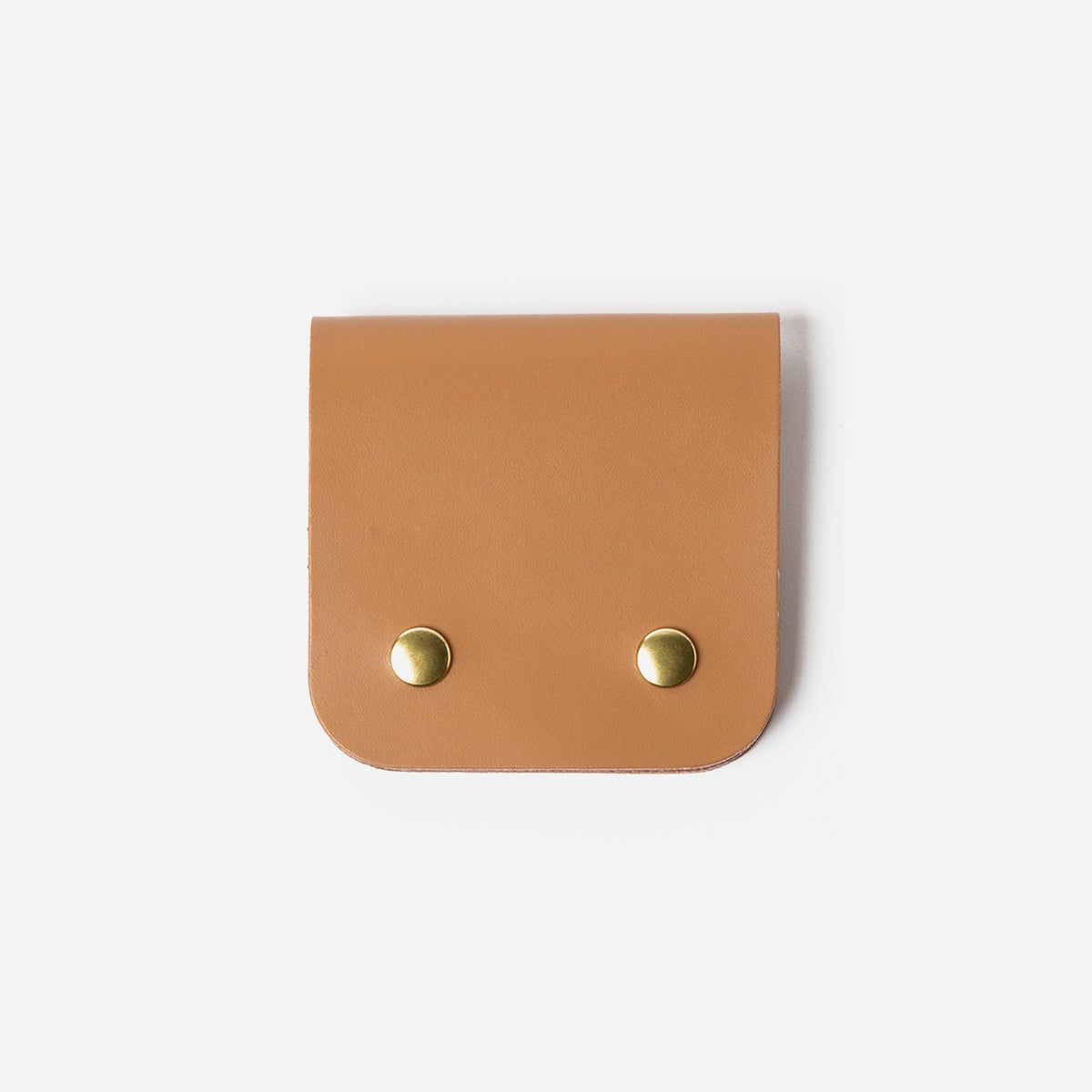 Brown leather pouch with gold studs on a white background - Saddle