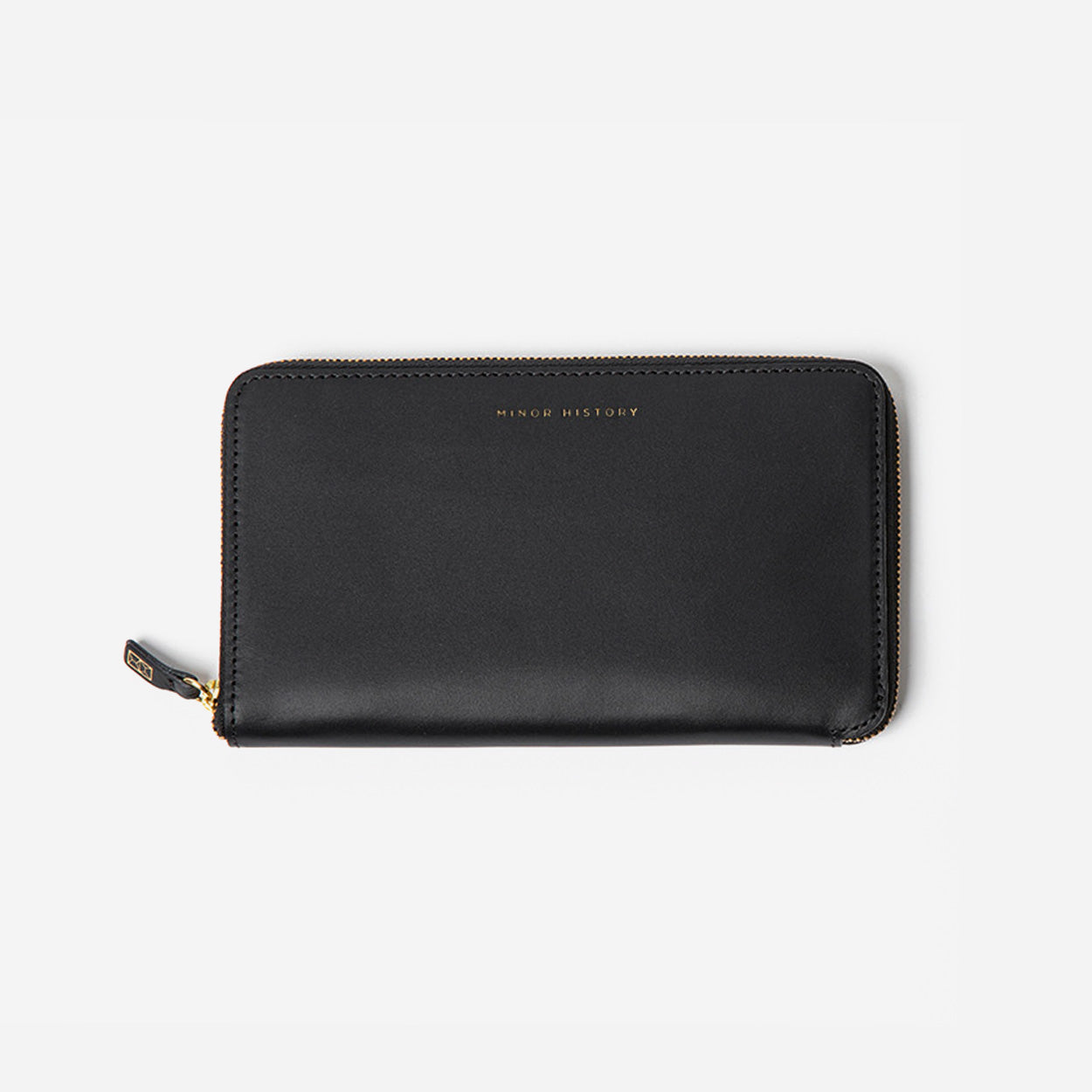 Black wallet with gold zipper on a light gray background - Black