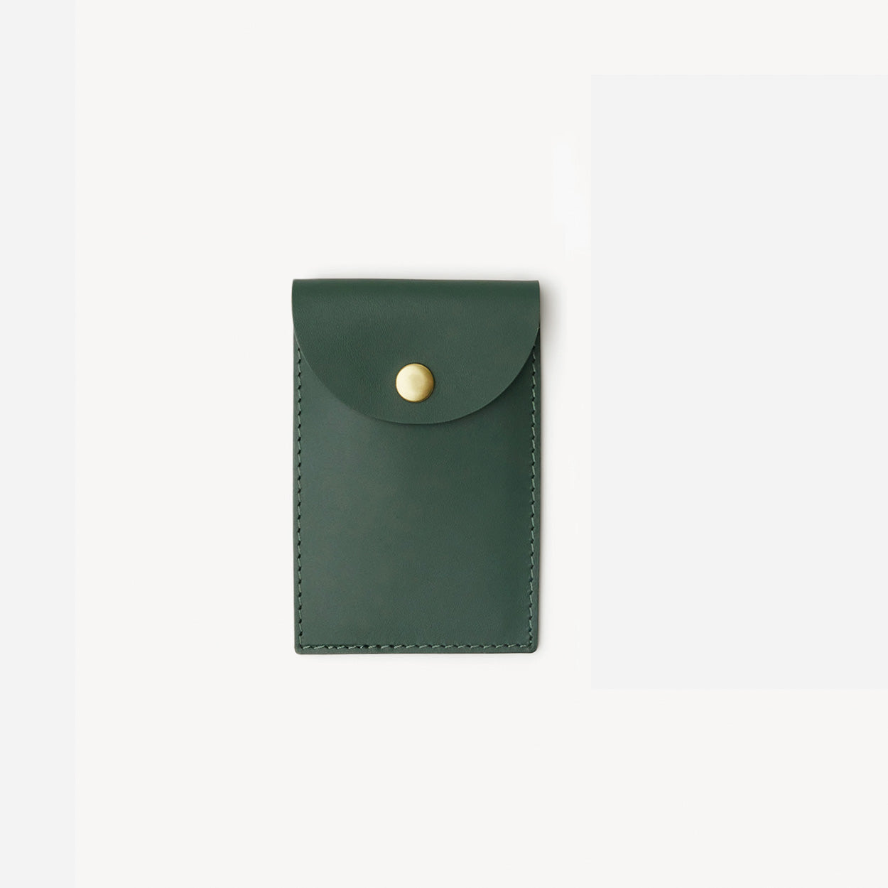Green leather card holder with a gold button on a white background - Evergreen