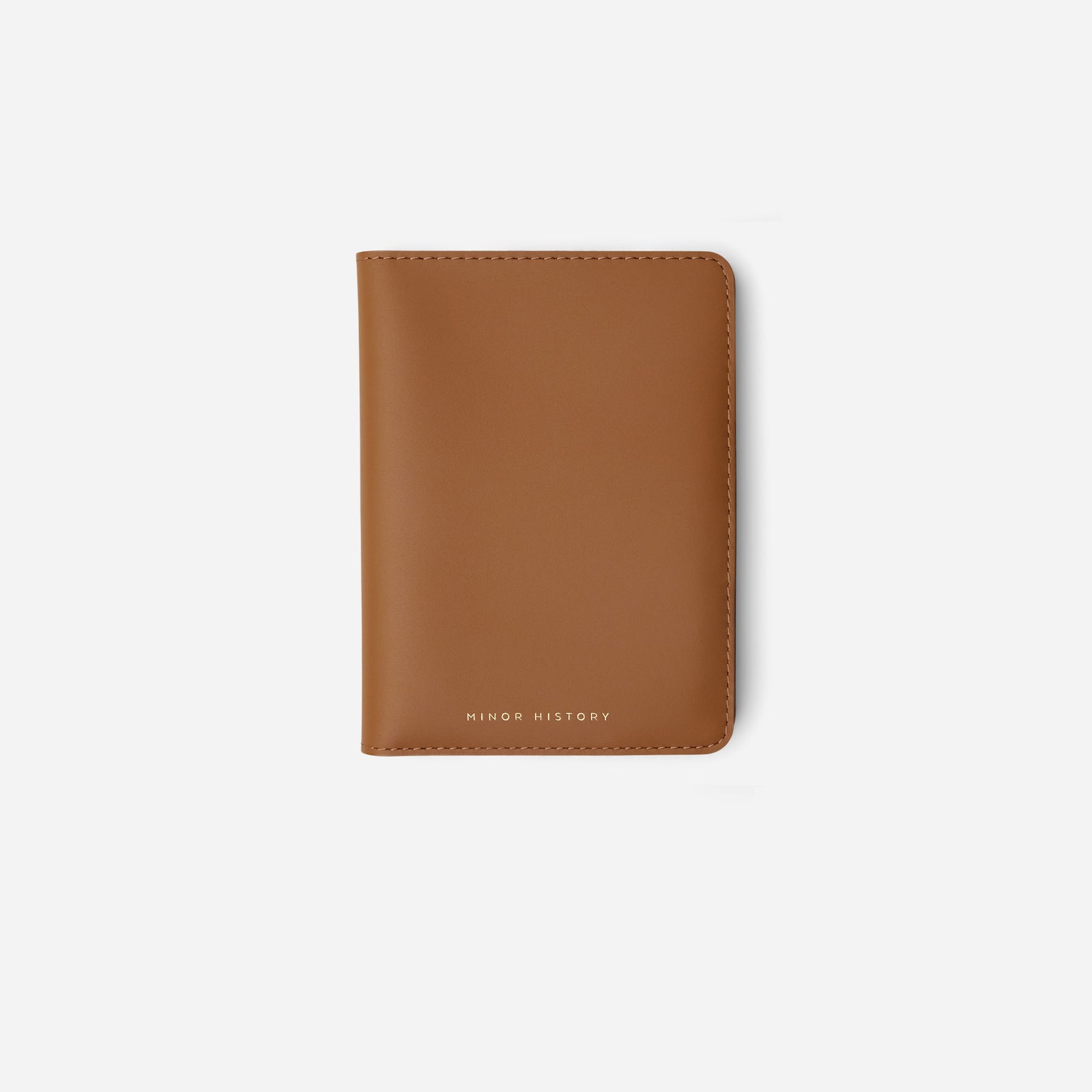 Atlas passport holder in black full-grain leather, side view highlighting slim profile