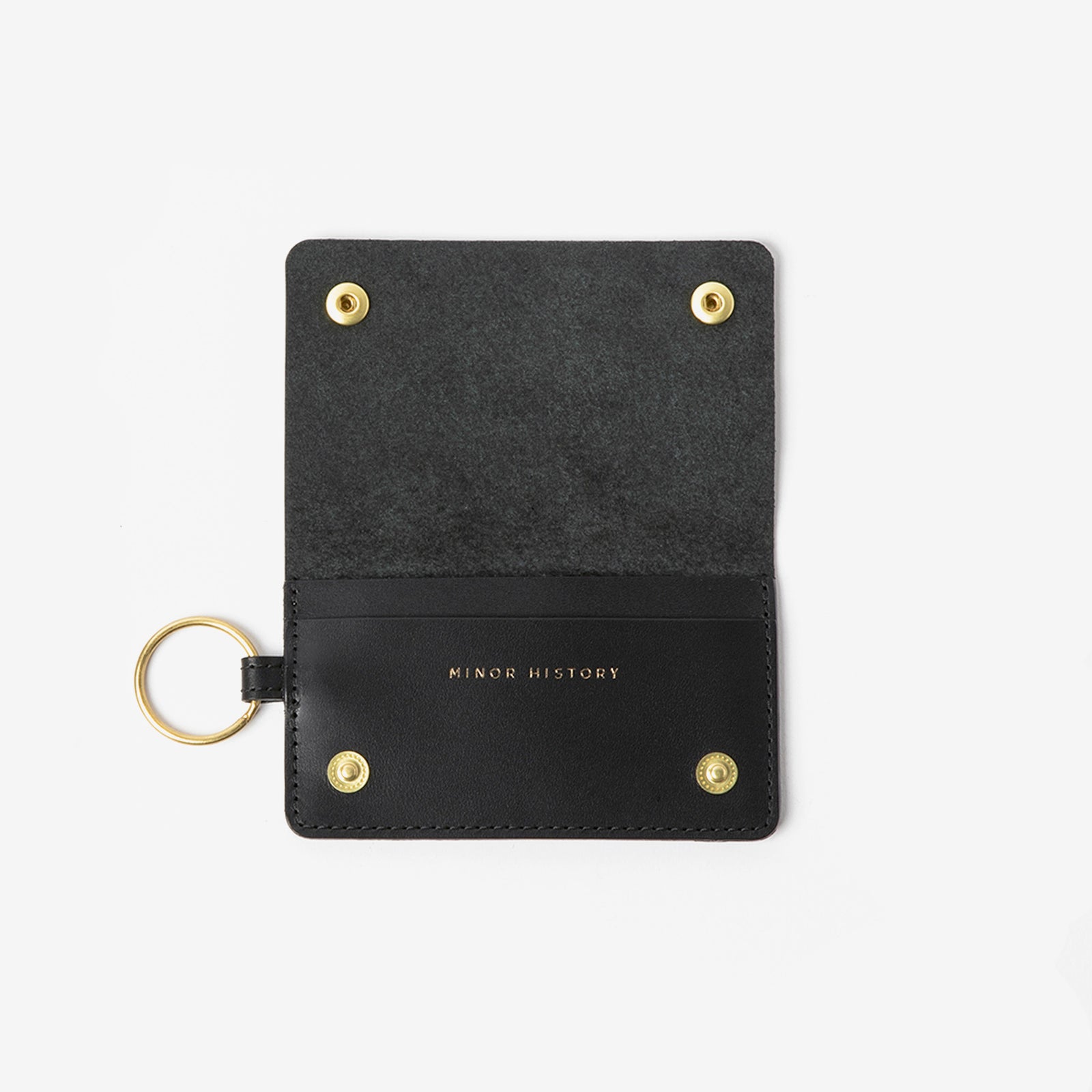 Black keychain cardholder with gold accents on a white background - Black