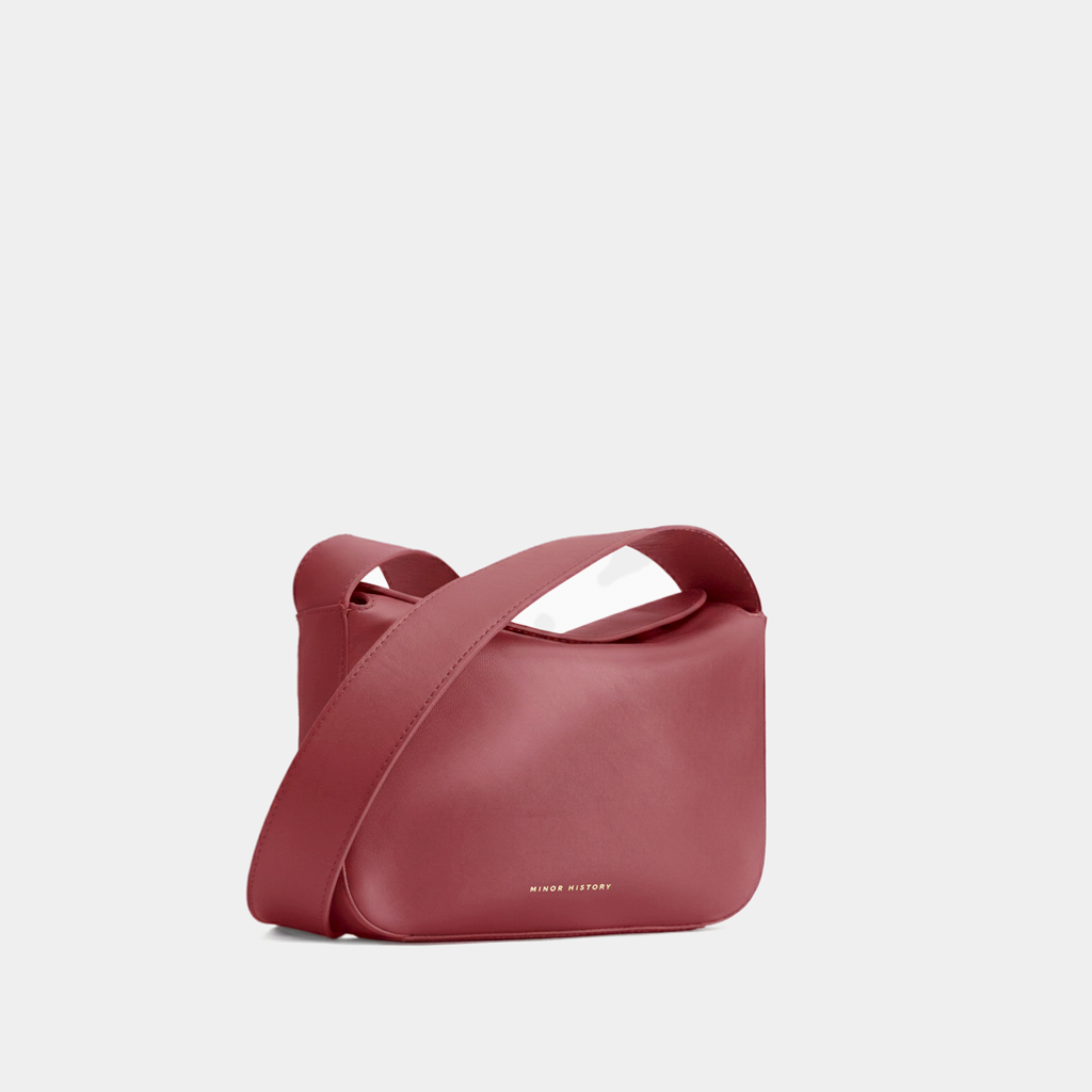 Black Leather Bag On Table With Plants