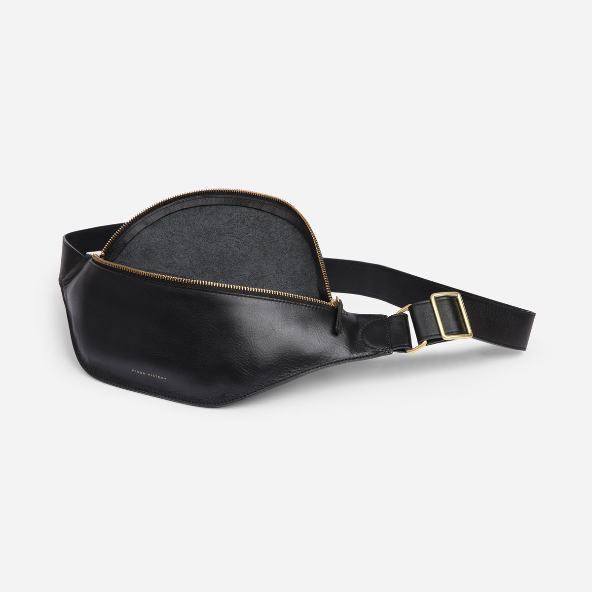 Crosstown fanny pack in black full-grain leather, lifestyle image styled with casual outfit