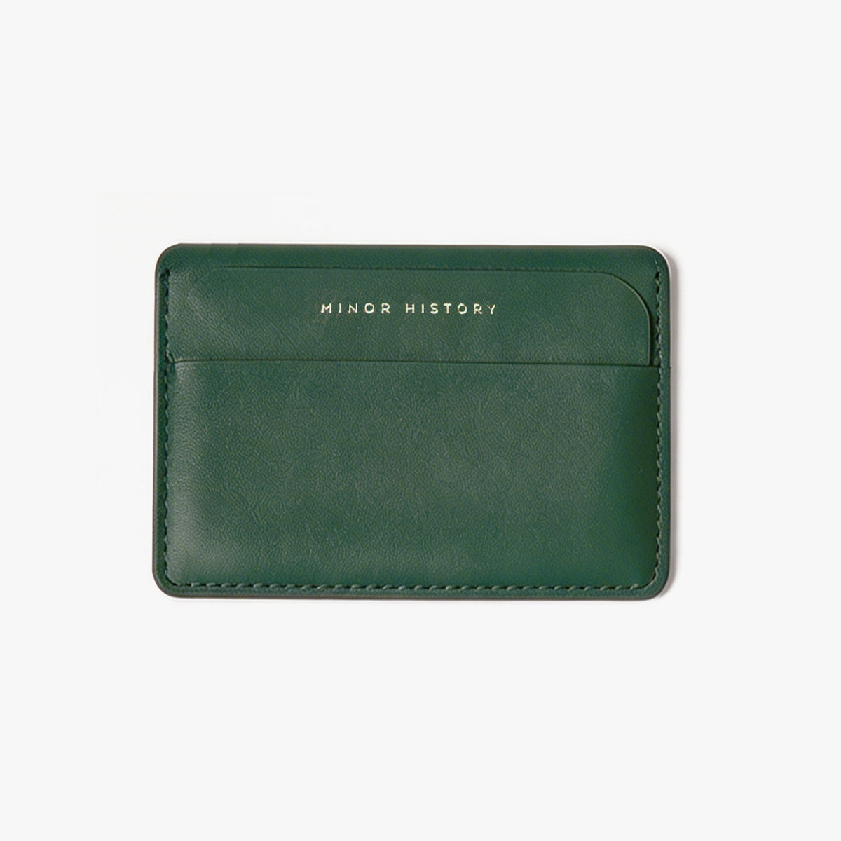 Green leather cardholder with 'MINOR HISTORY' branding on a white background - Evergreen