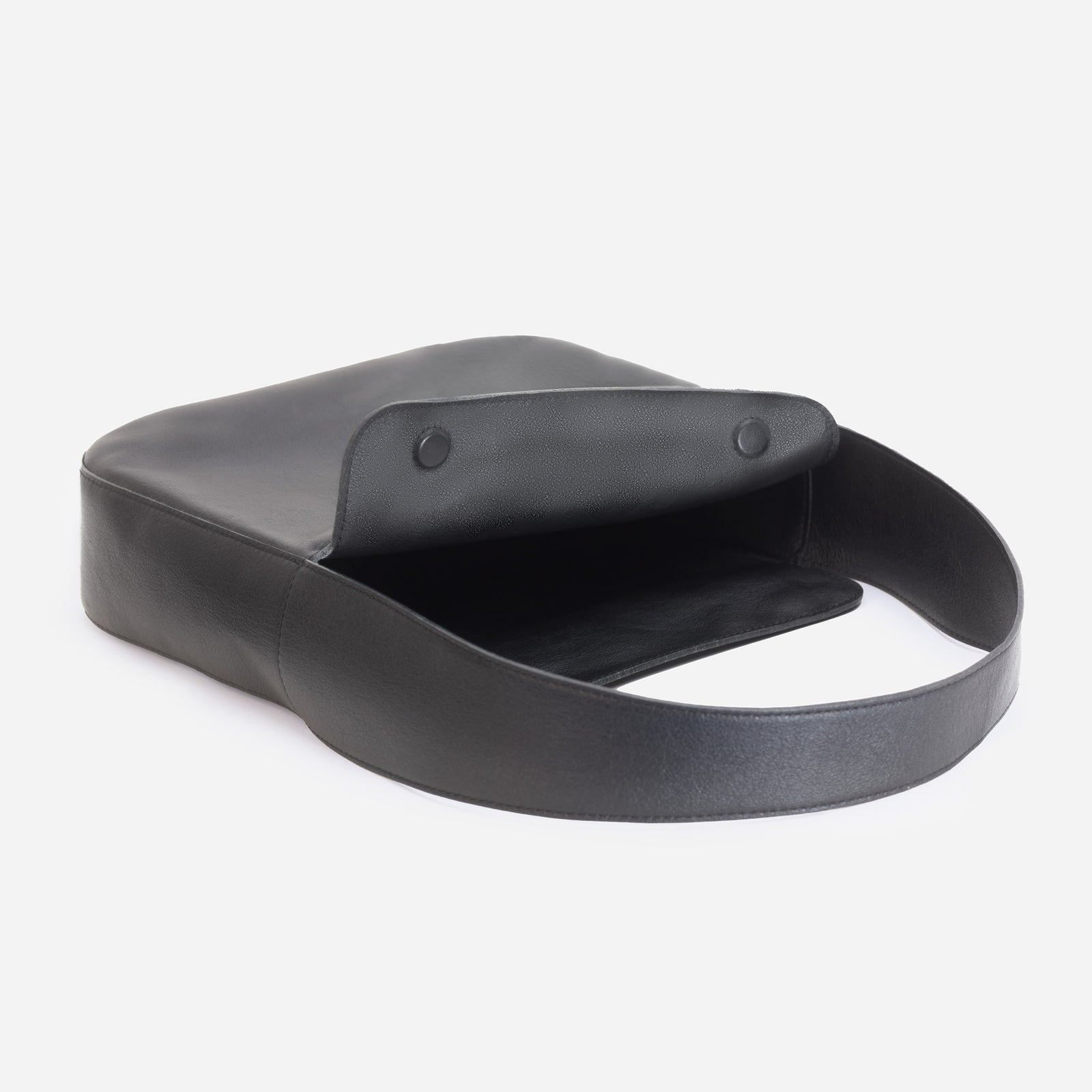 Frame Bag in black full-grain leather, detailed studio shot capturing texture and strap design