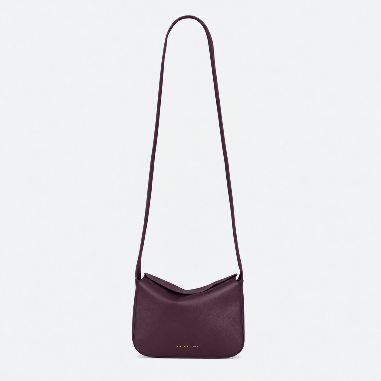 Little Frame crossbody bag in black full-grain leather, front view showcasing its sculpted shape, minimalist women's handbag - Black