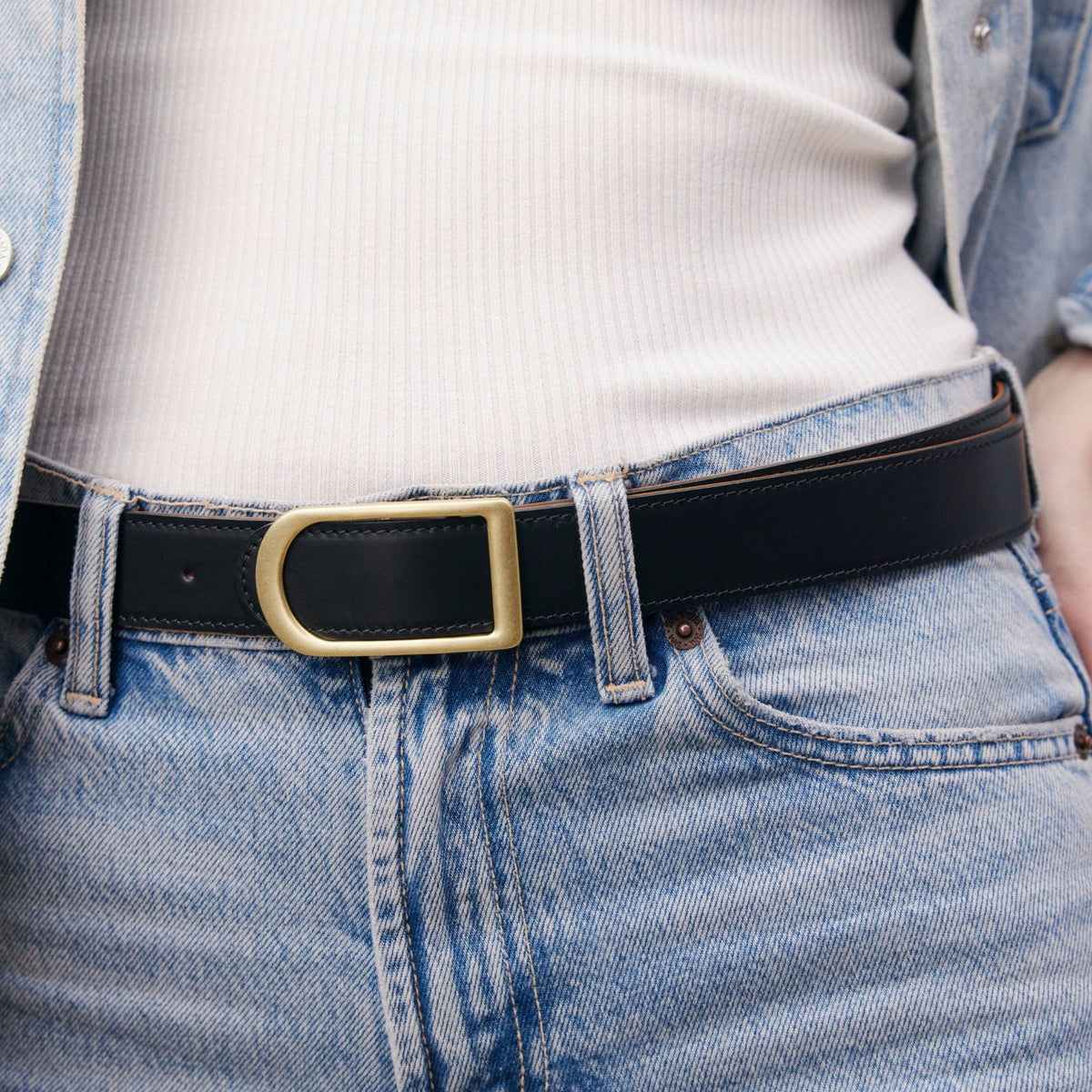 Gemini reversible belt in black full-grain leather with brass buckle, minimalist fashion accessory for everyday wear