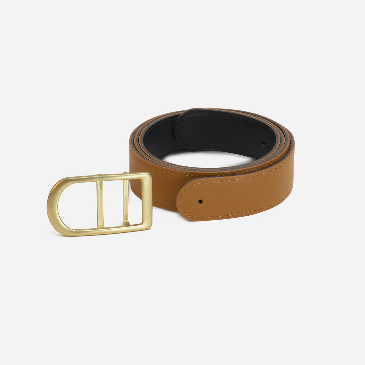 Gemini reversible belt in black and saddle brown full-grain leather with brass buckle, close-up of buckle and leather texture