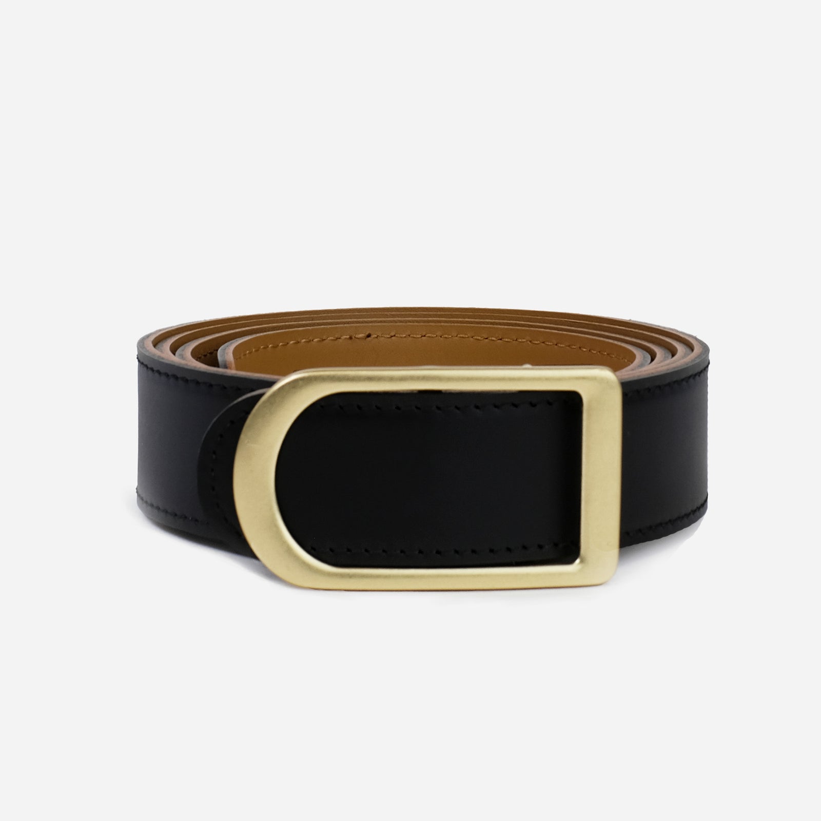 Gemini reversible belt in black and saddle brown full-grain leather with brass buckle, side view focusing on reversible color contrast
