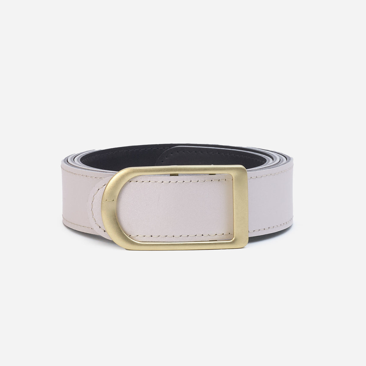 Gemini reversible belt in black full-grain leather with brass buckle, close-up of buckle and leather texture
