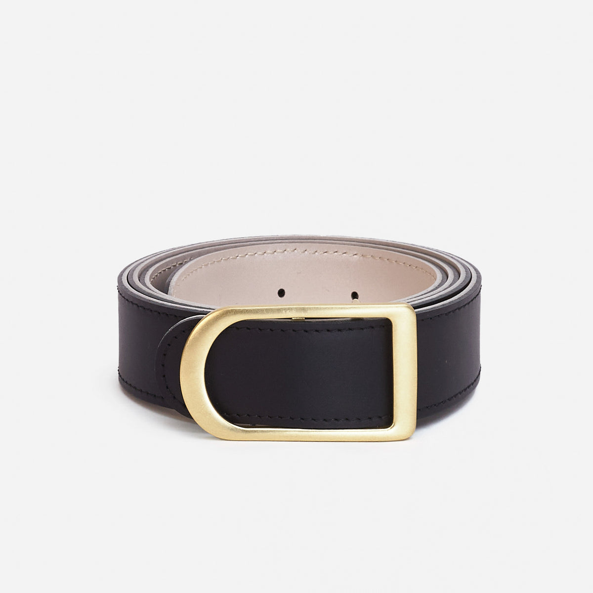 Gemini reversible belt in black full-grain leather with brass buckle, refined product shot for e-commerce listing