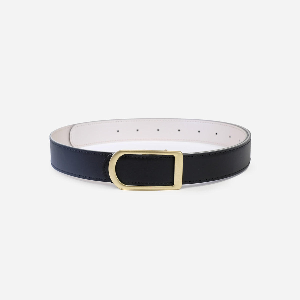 Gemini reversible belt in pearl white full-grain leather with brass buckle, side view focusing on reversible color contrast