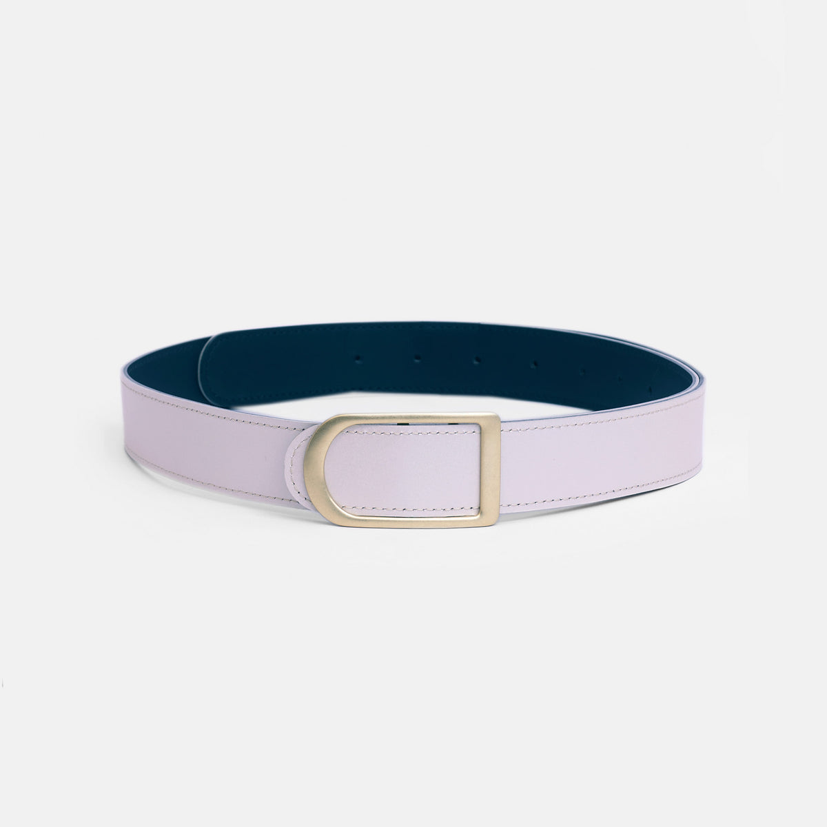 Gemini reversible belt in pearl white full-grain leather with brass buckle, displayed in bright studio with soft shadows