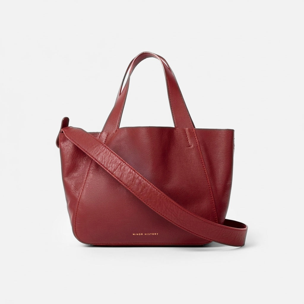 Red handbag with a shoulder strap on a light gray background - Cherry Cola