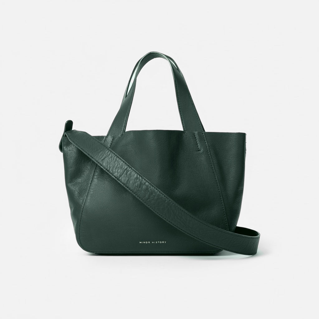 Green handbag with a shoulder strap on a light gray background - Evergreen
