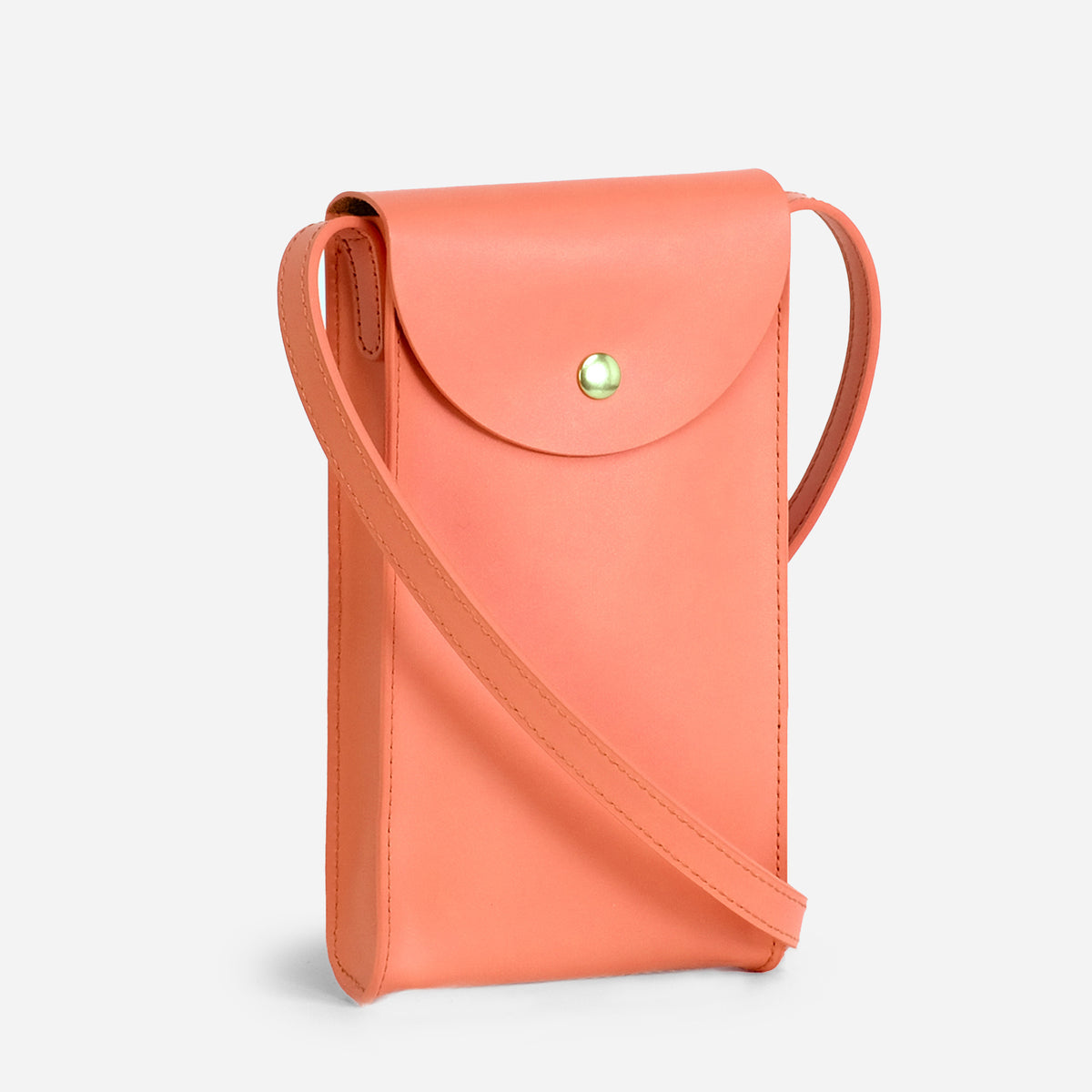 Mini Bandit crossbody bag in paloma pink full-grain leather, front view in bright studio setting