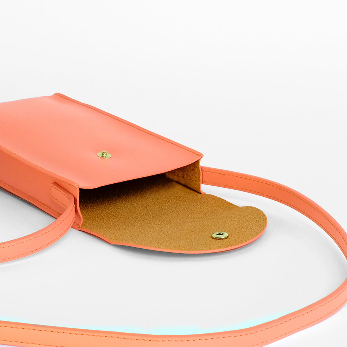 Mini Bandit crossbody bag in paloma pink full-grain leather, lifestyle image styled with casual outfit