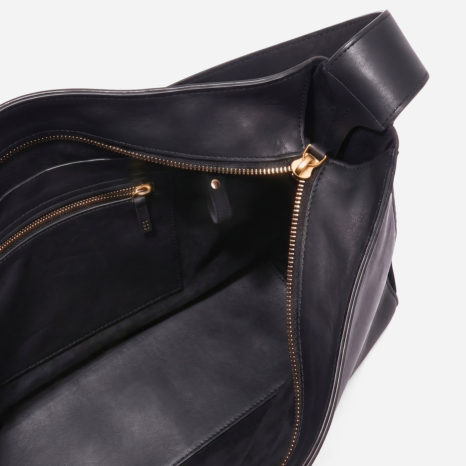 Black leather bag with gold zipper on a white background -Black