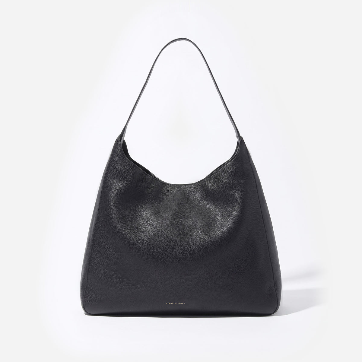 Black Overtime Tote, front view showing the curved top and shoulder strap - Black