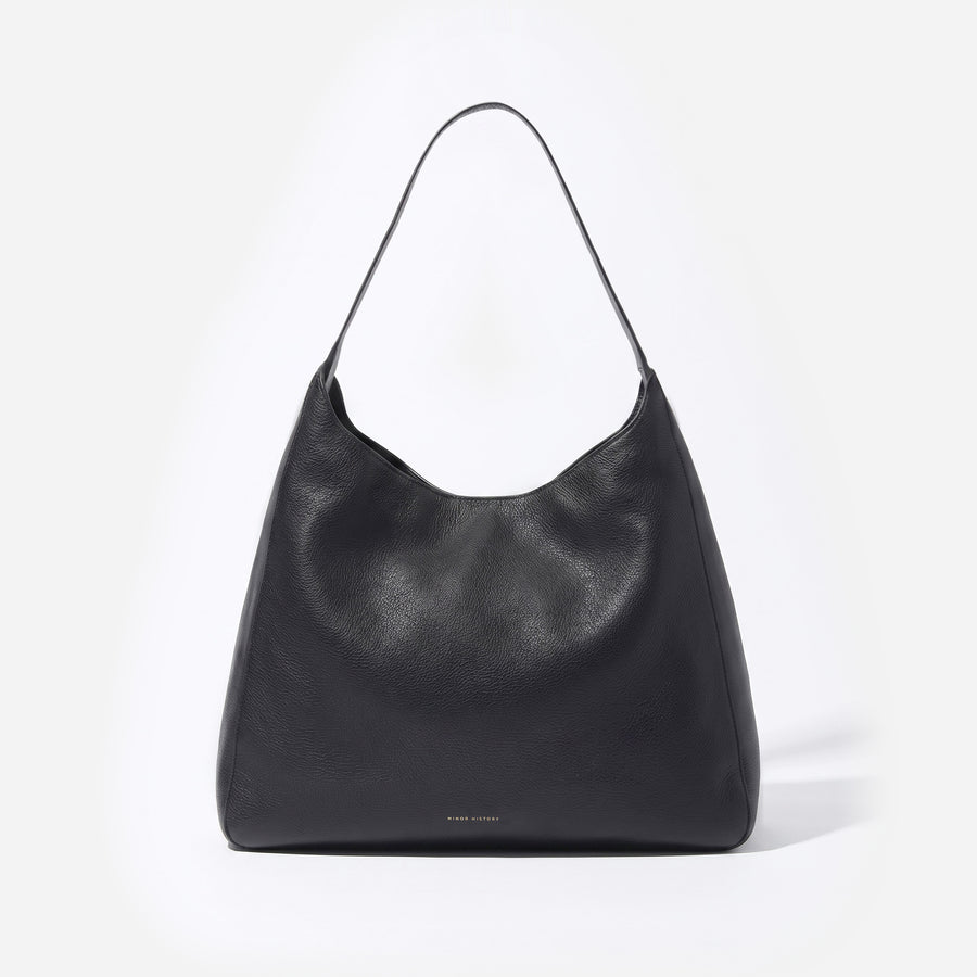 Black Overtime Tote, front view showing the curved top and shoulder strap - Black