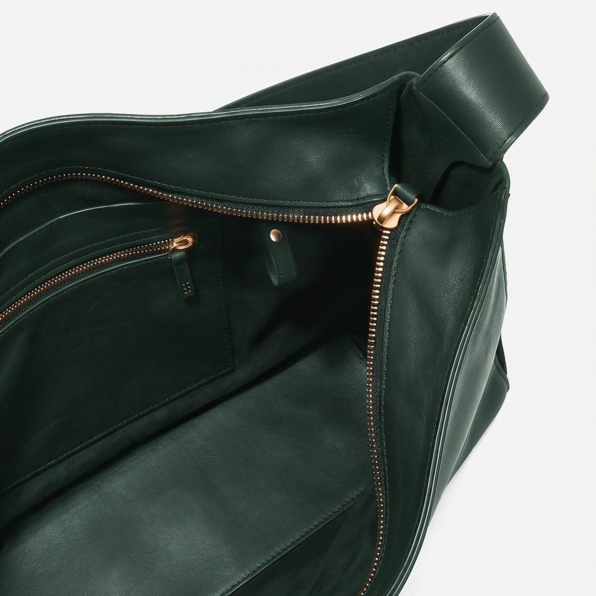 Green leather bag with gold zipper on a white background  - Evergreen