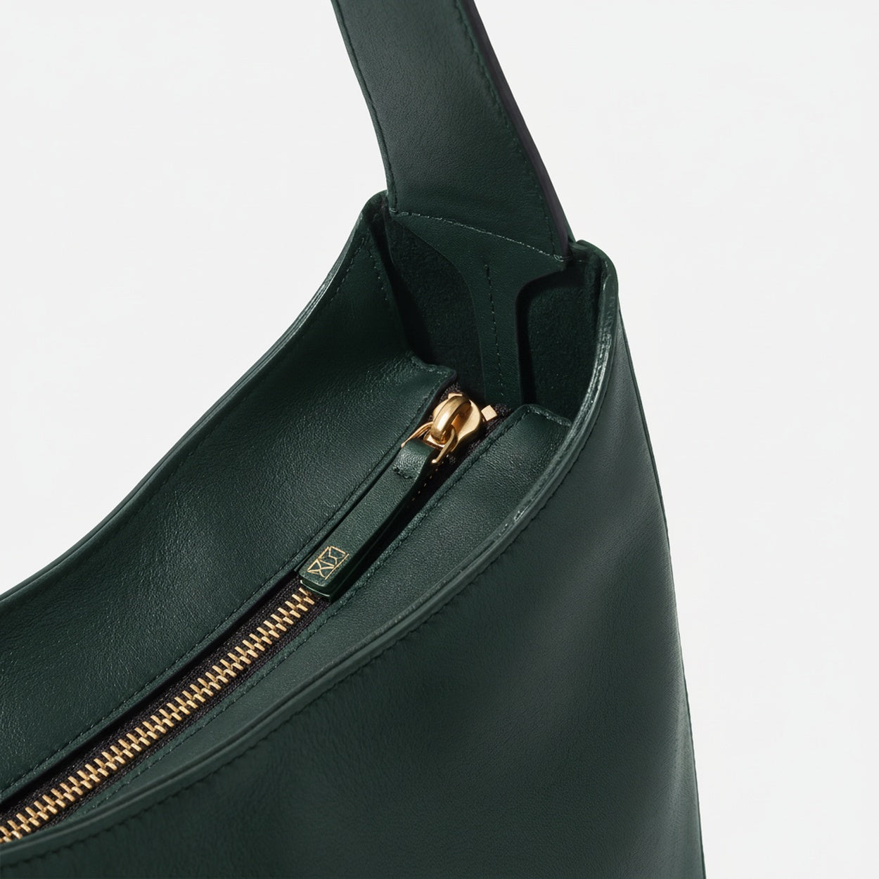 Black handbag with gold zipper on a light gray background  -Evergreen