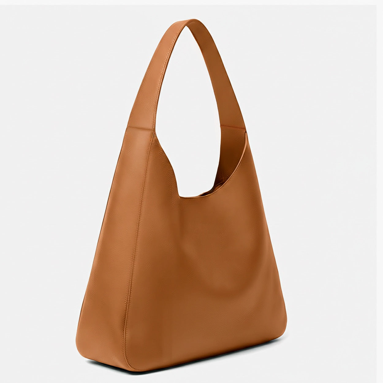 Brown leather handbag on a light gray background - Saddle