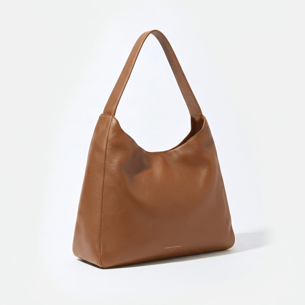 Brown leather handbag on a white background - Saddle
