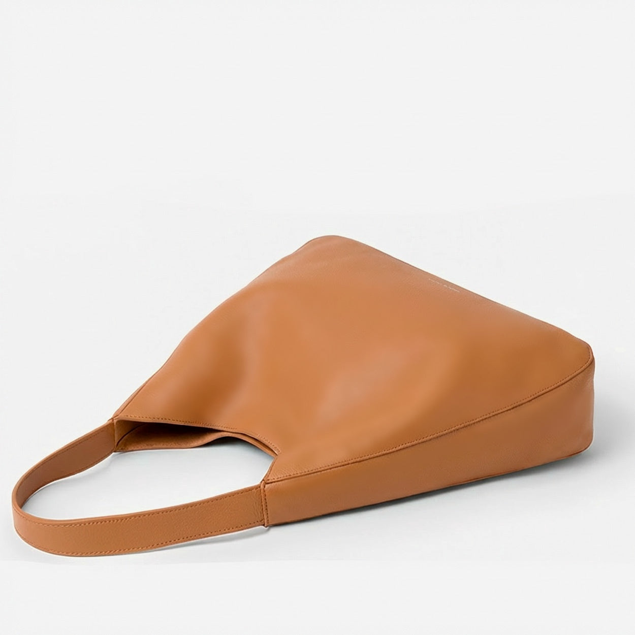 Brown leather handbag on a white background - Saddle