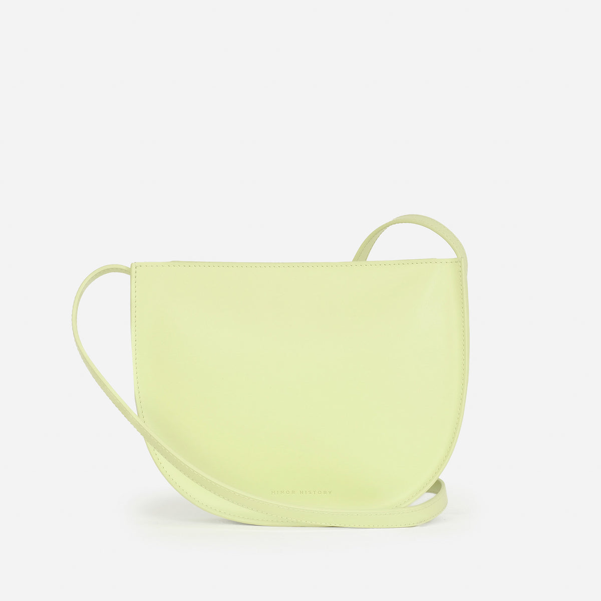 Sidekick Crossbody in limelight leather, lifestyle background