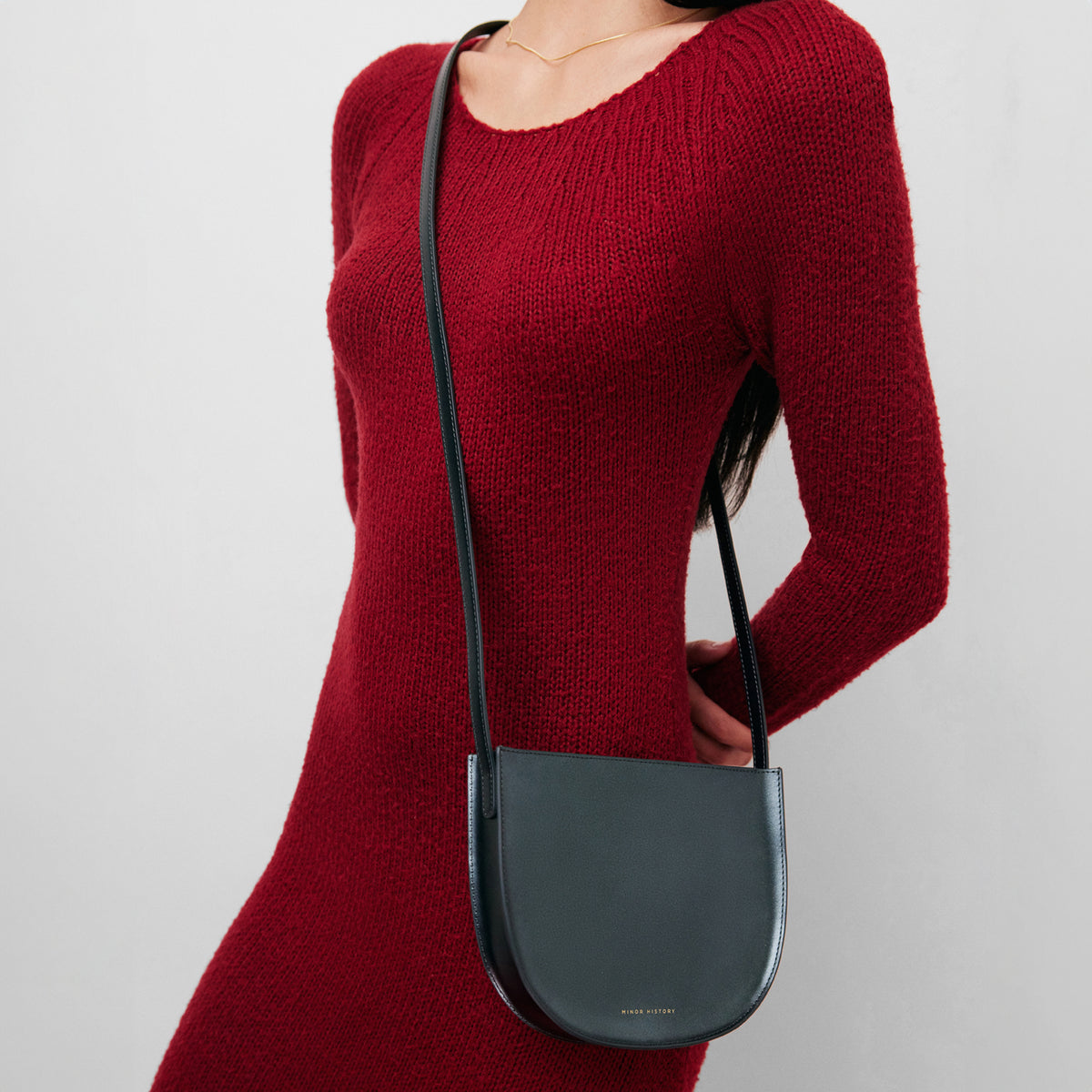 Sidekick Crossbody in jet black leather, cropped lifestyle image