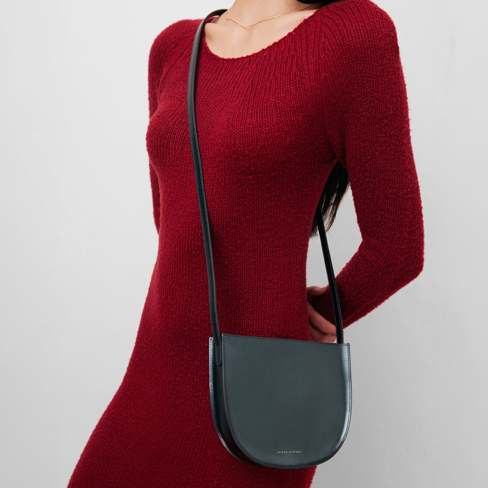 Sidekick Crossbody in jet black leather, cropped lifestyle image