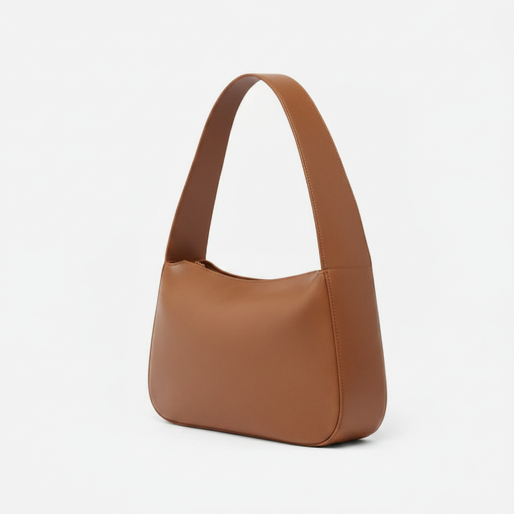 Brown leather handbag on a light gray background - Saddle